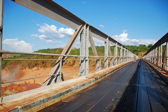 Madagascar, Bestiboka, white man walking on the bridge over red river