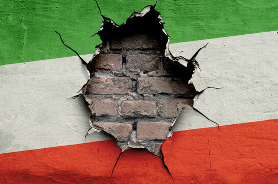 flag of the Islamic Republic of Iran are painted on an old wall with a cracked