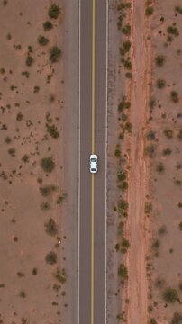 Top down aerial ascend above car on Recta del Tin Tin highway in Salta, drone vertical background