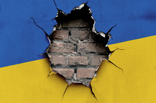 flag of the Ukraine are painted on an old wall with a cracked