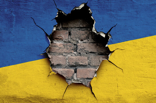 flag of the Ukraine are painted on an old wall with a cracked