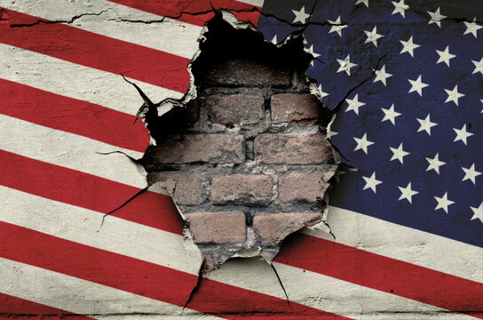 national flag of the United States of America is painted on an old wall with a large hole