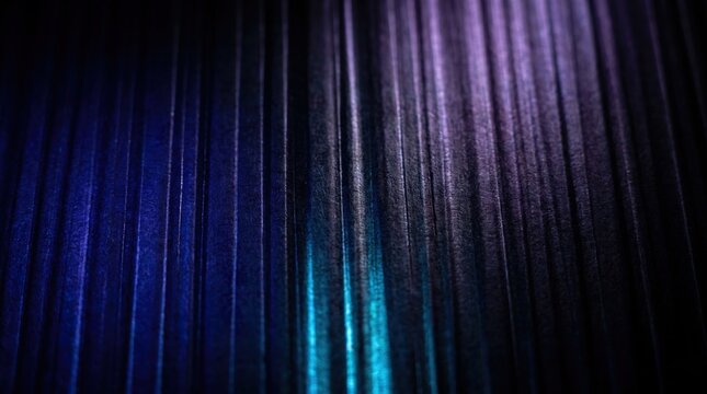 Abstract background with vertical ribbed texture illuminated by cool blue and purple neon lights creating a modern digital pattern for design projects.