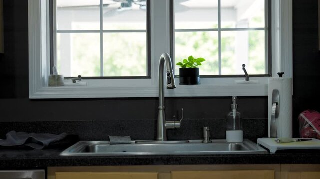 Bright kitchen sink illuminated by natural sunlight, ideal for home interiors, real estate, remodeling, kitchen design, and lifestyle visuals.