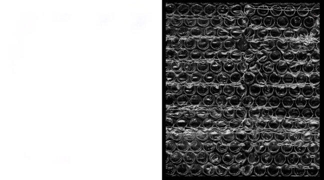 Industrial bubble wrap texture on black background, plastic packaging material pattern, protective cushioning wrap for shipping