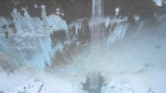 Aerial orbit revealing the frozen cliffs of Peričnik Waterfall in Slovenia, wide view