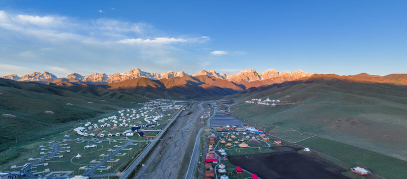 Aerial View of Maya Snow Mountain at Sunrise with Tibetan Tent Camps in Valley