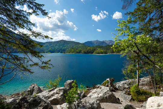 Travel landscape of Eibsee lake and  mountain peak in Alps in Bavaria,  Germany, scenic summer nature panorama with forest und mountains. Alpine landscape