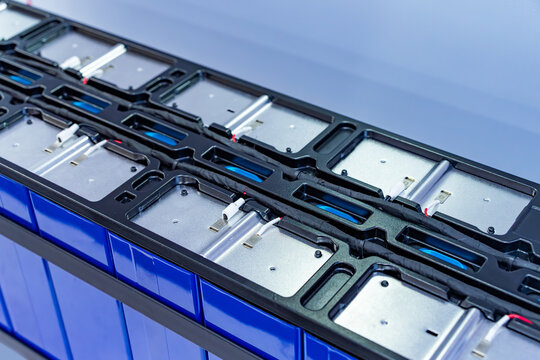 Electric car lithium battery pack and wiring connections internal between cells on background.