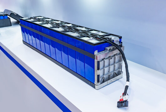 Electric car lithium battery pack and wiring connections internal between cells on background.