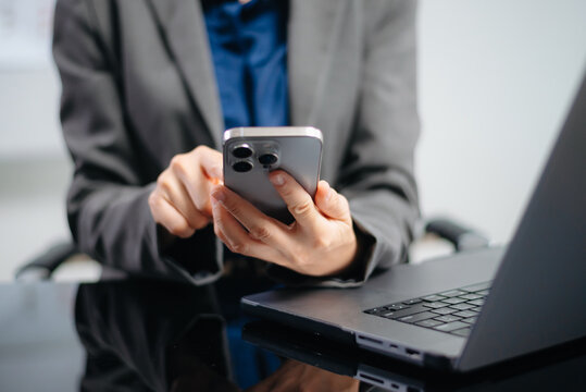 Woman hand using smart phone, tablet payments and holding credit card online shopping, omni channel, digital tablet docking keyboard computer at office in sun light.