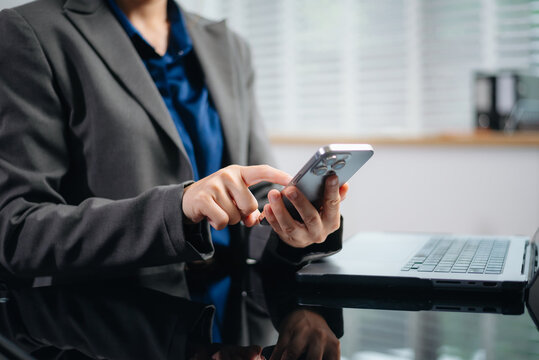 business documents on office desk with laptop and smart phone and graph business diagram and man working in morning light