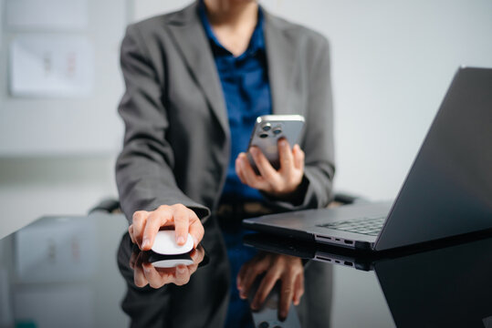 Woman hand using smart phone, tablet payments and holding credit card online shopping, omni channel, digital tablet docking keyboard computer at office in sun light.