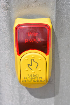 Yellow pedestrian crossing button with Croatian text