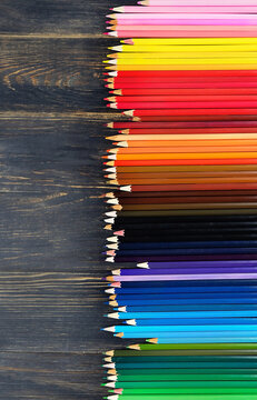 border of assorted of color pencils close up on rustic wooden background. set of many colorful wooden pencils. Drawing supplies, tool for artists. top view. Template for design. copy space