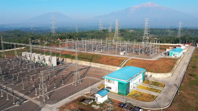 Aerial view of Ampel 150kV Substation with Merbabu and Merapi mountains in the background, Kecamatan Ampel, Jawa Tengah, Indonesia.