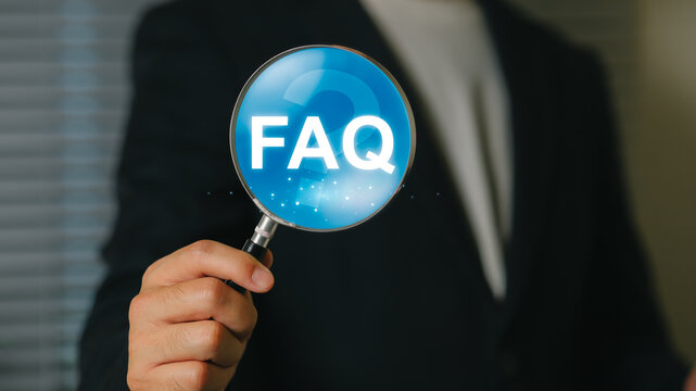 Business professional holding magnifying glass with FAQ text for customer support and inquiry