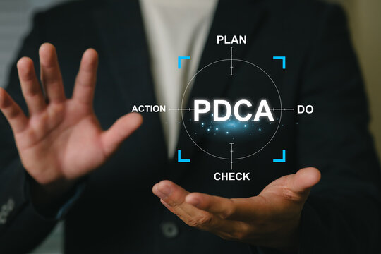 Businessperson Holding Digital PDCA Cycle for Process Improvement and Planning