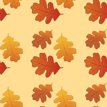 Autumn seamless pattern with orange oak leaves on a pale background