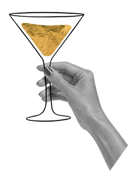 Female hand holding martini glass. Golden cocktail celebration concept. New year party