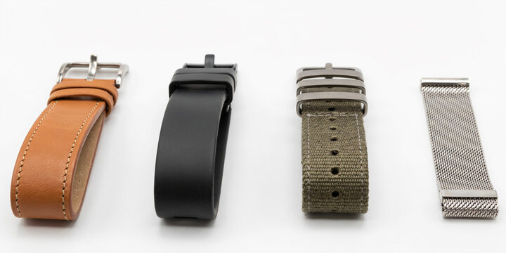 Four different watch straps including leather, rubber, fabric, and metal mesh bands