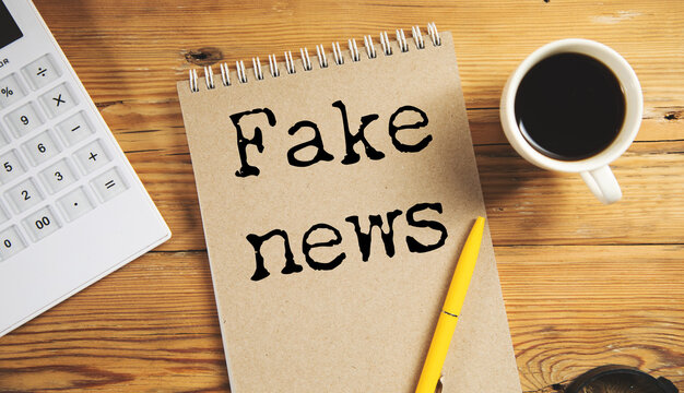Fake news concept with torn paper