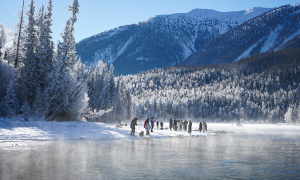 Winter morning mist over frozen river at Kanas Lake, Xinjiang, China