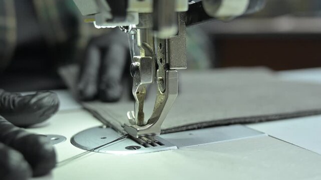 A close-up of a sewing machine at work. 