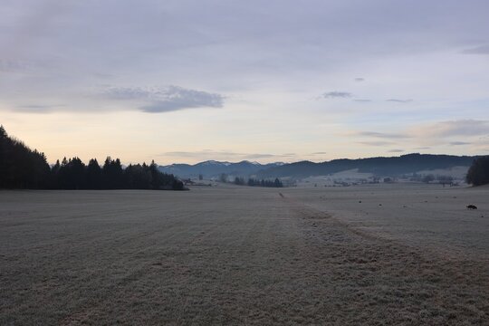 Frosty Meadow Landscape at Dawn with Mountain Range