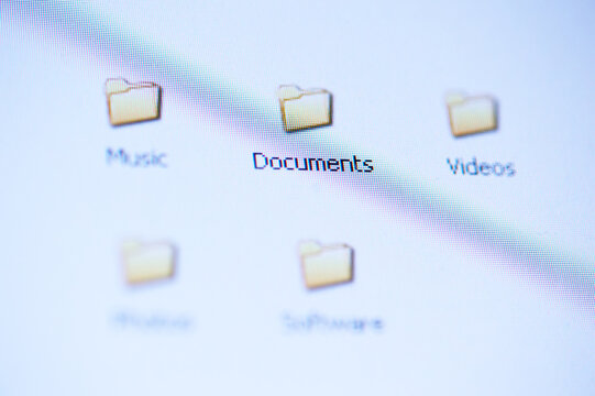 Close-Up Of Computer Desktop Folders Labeled Documents, Music And Videos Showing Digital File Organization