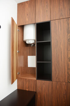 Hidden water heater in wooden cabinet
