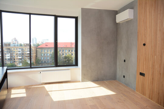 Loft interior with wooden floor and air conditioner