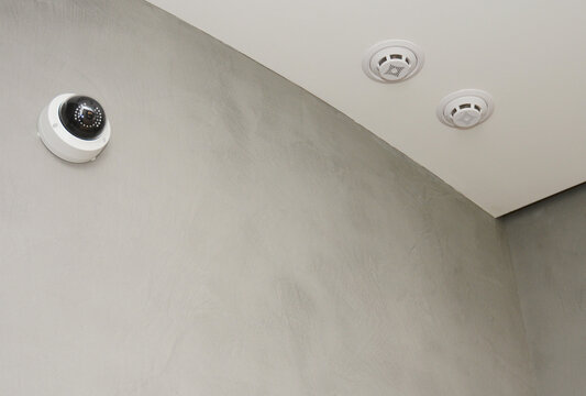 Home security camera and smoke detectors indoors