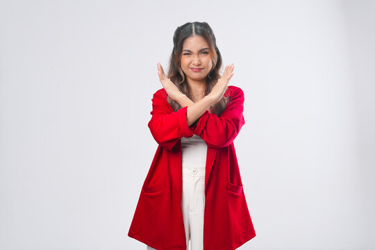 Attractive young Asian woman showing hand gesture pose rejection or prohibition.