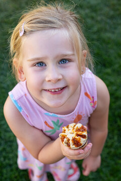 Smiling Little Girl Eating Ice Cream Outdoors