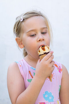 Little Girl Holding Ice Cream Cone and Looking at Camera