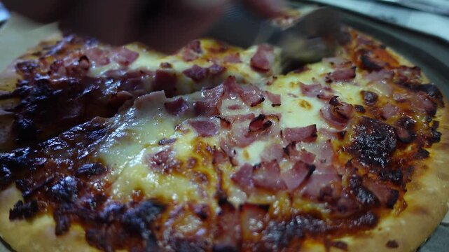 cutting delicious homemade pizza close up