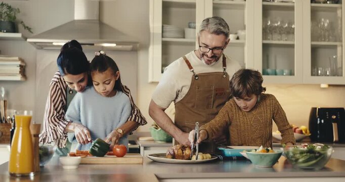 Cooking, high five and family in kitchen at house for bonding, care and learning culinary skills. Smile, celebration and children with parents for preparing dinner, meal or supper for development.