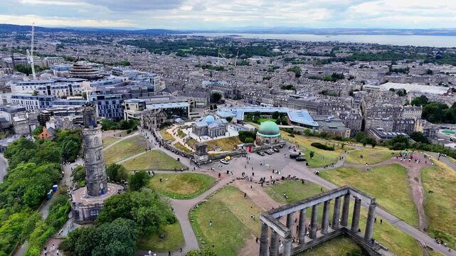 Stunning drone flyover revealing Calton Hill and Edinburgh's historic skyline. Scotland.