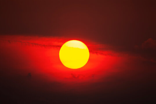 Tramonto rosso infuocato dietro le nuvole