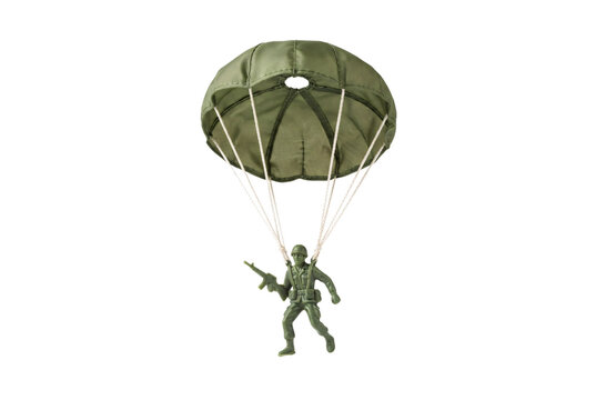 Green plastic toy soldier paratrooper floating with a deployed parachute holding a rifle toy military figure.