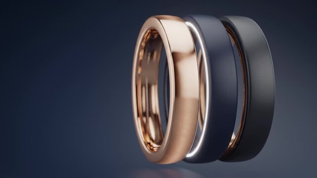 Three Modern Smart Rings Rotating in Studio Lighting