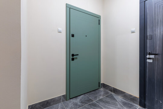 Apartment Entryway Interior with Green Entrance Door and Tiled Floor