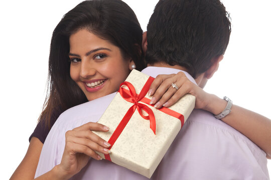 Portrait of a woman holding a gift smiling