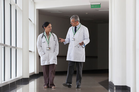 Two doctors talking in corridor of hospital
