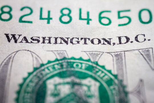 Macro close up of United States one dollar bill. American dollar background. Detailed dollars money texture. Selective focus, shallow depth of field
