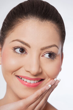 Woman touching her face and looking away 