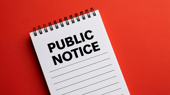 Elegent photo of Public notice text written on a spiral notepad against a bold red background. Symbolizes official corporate communications and government announcements.
