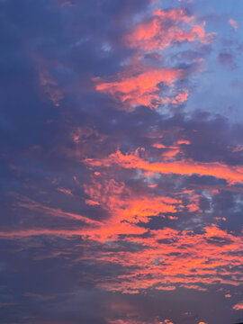 Dramatic sunset sky with glowing pink and purple clouds creating a beautiful natural background.