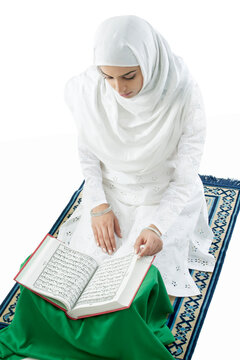 Muslim woman reading the Quran 
